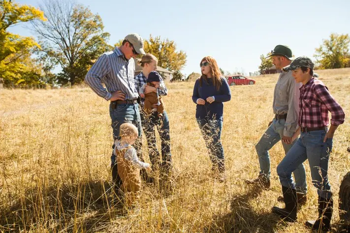 Lucinda with farmers in a field