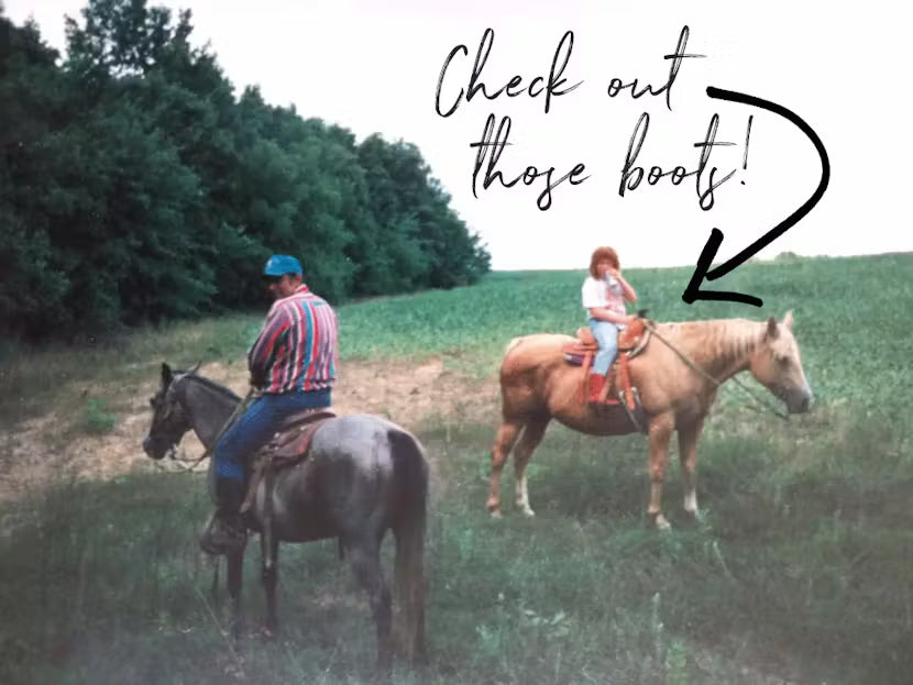 Two people riding horses in a grassy field with text pointing to one of the riders' boots.