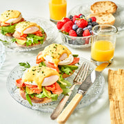 Breakfast table with Eggs Benedict and fresh berries.