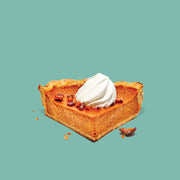 Slice of pumpkin pie with whipped cream on a teal background