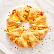Baked breakfast crescent ring on a white plate