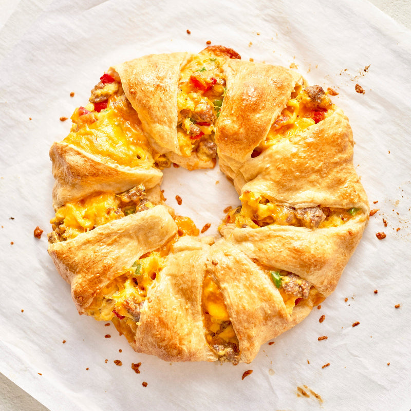 Baked breakfast crescent ring on a white plate